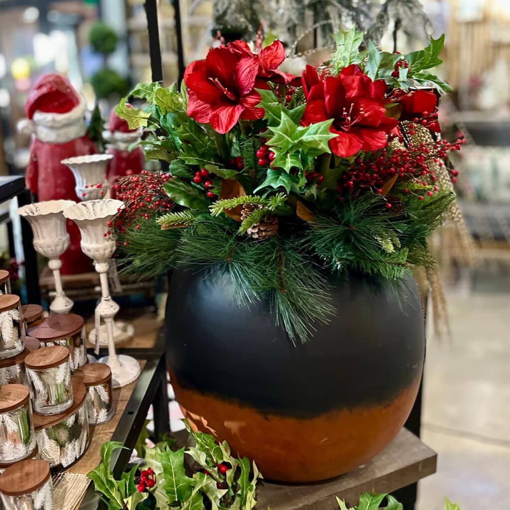 Artificial poinsettia branches in container