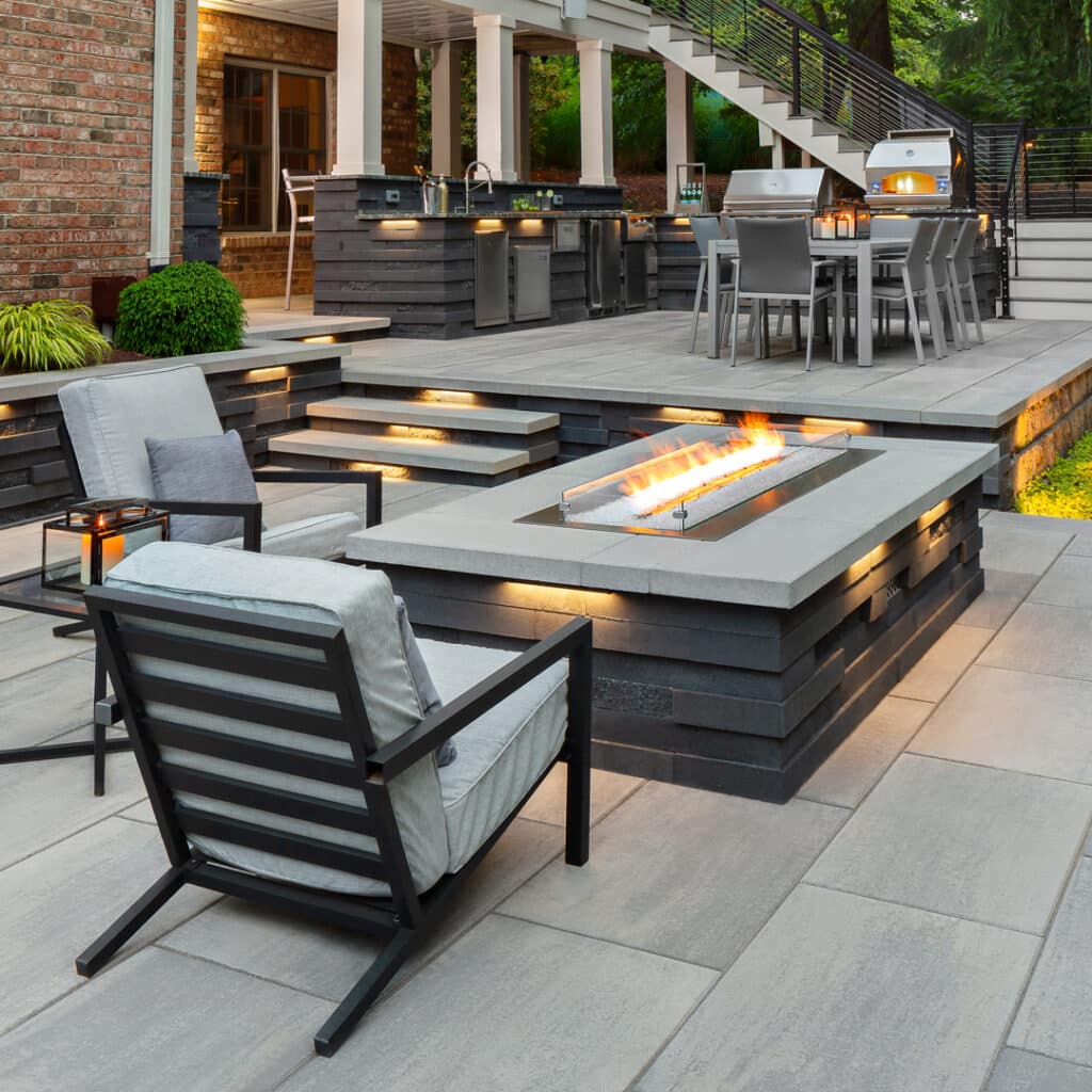 Gas fire table with fire burning on lower patio