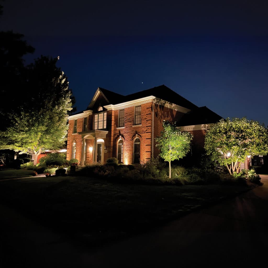 Home illuminated with the soft glow of low voltage landscape lights at night