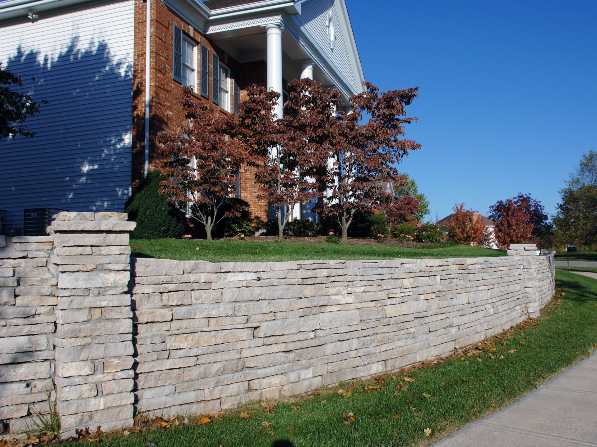 Large natural stone wall on residential property