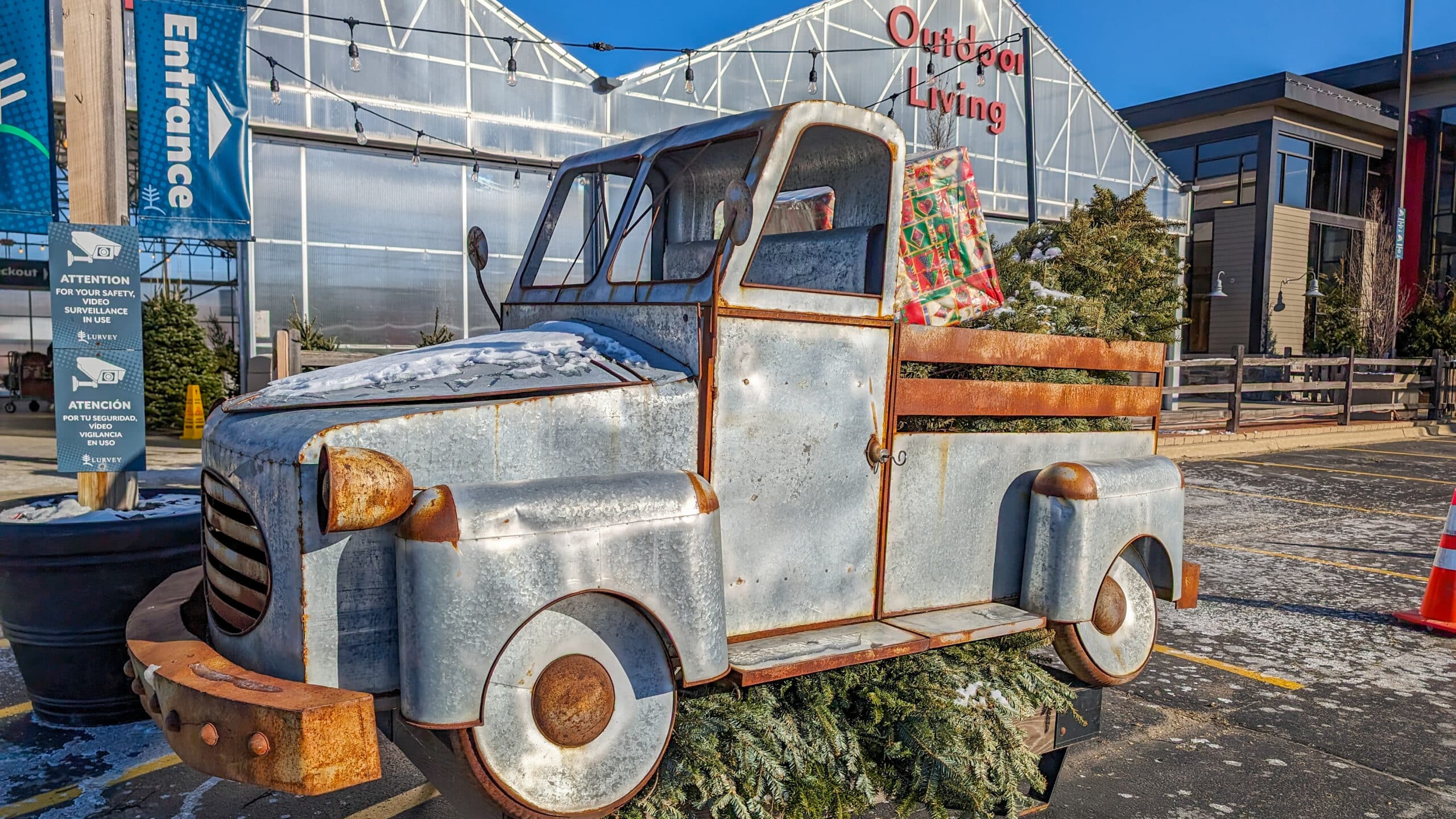 Metal truck with holiday favorites - live greens and Christmas trees