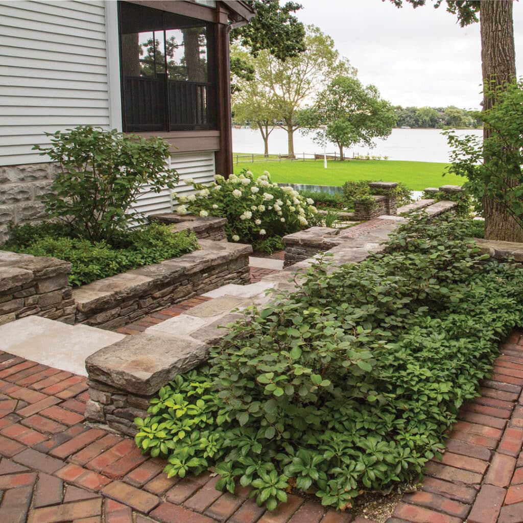 Reclaimed clay paver pathway between outdoor living areas