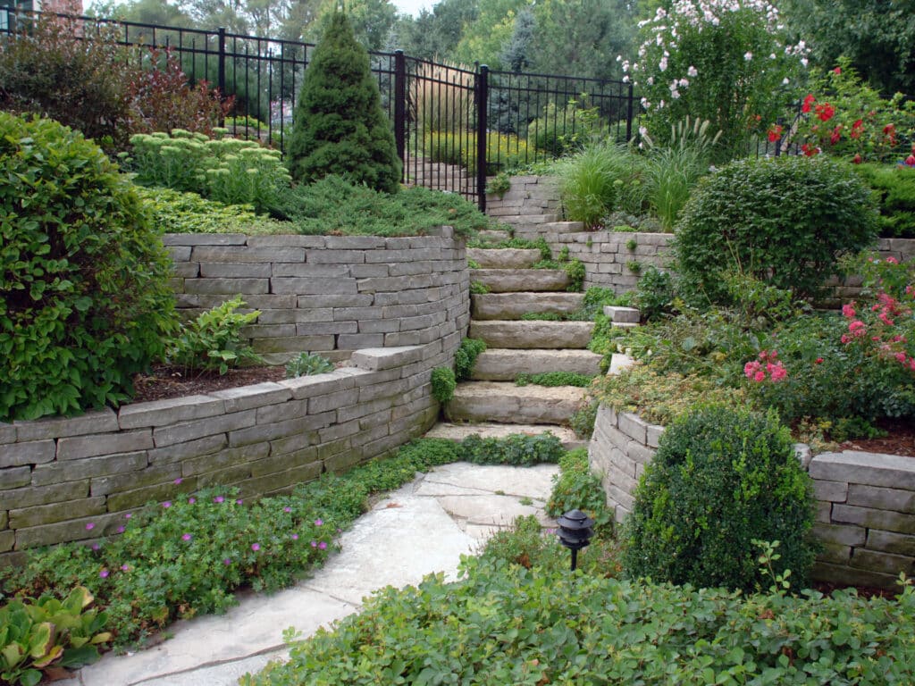 Natural stone walls, steps and pathway through a natural garden